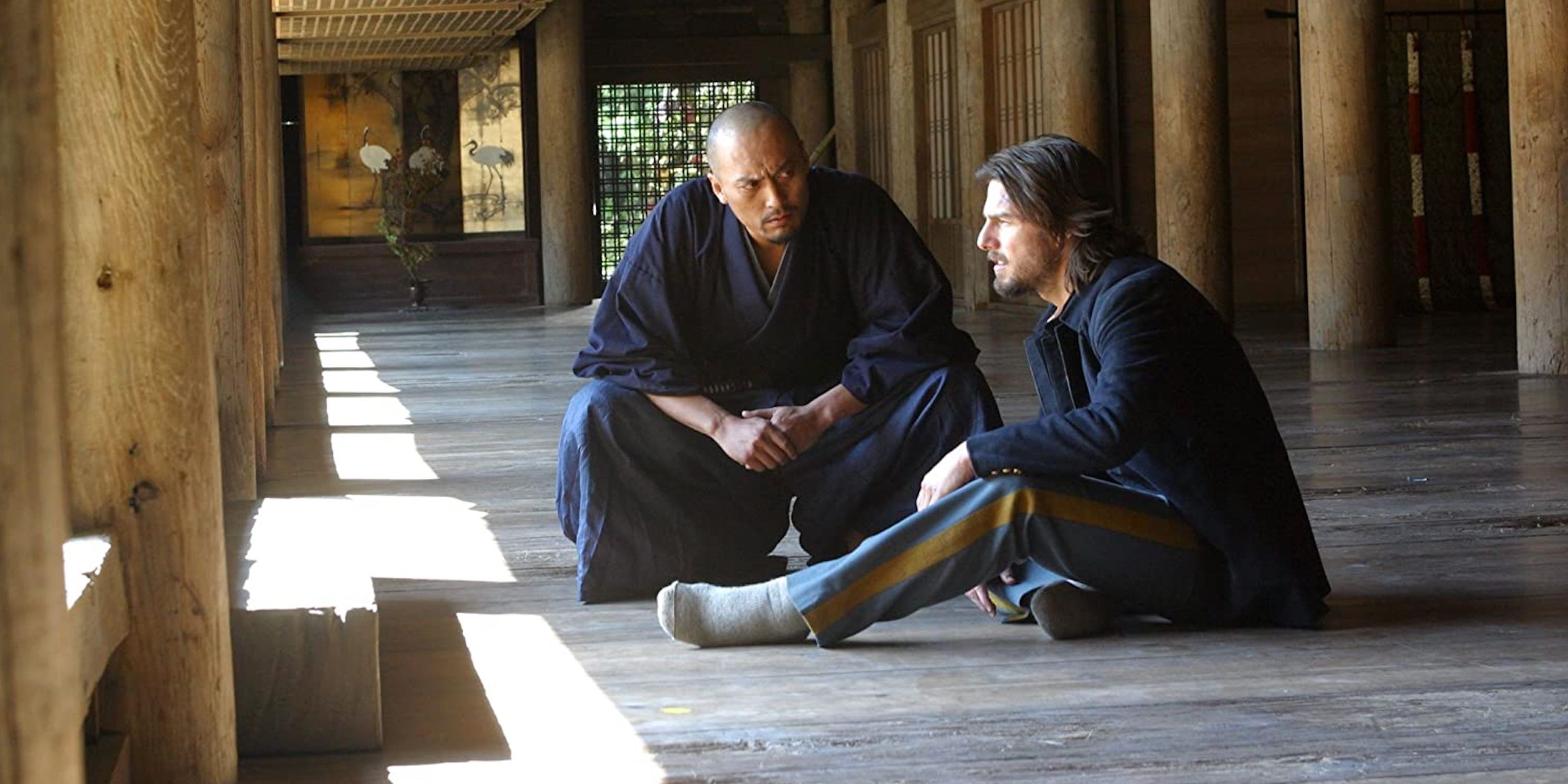 Ken Watanabe and Tom Cruise sitting on the floor in The Last Samurai