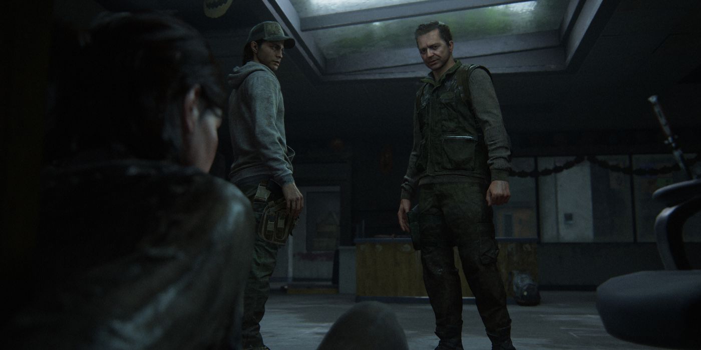 Two men stare down at Ellie in The Last of Us II