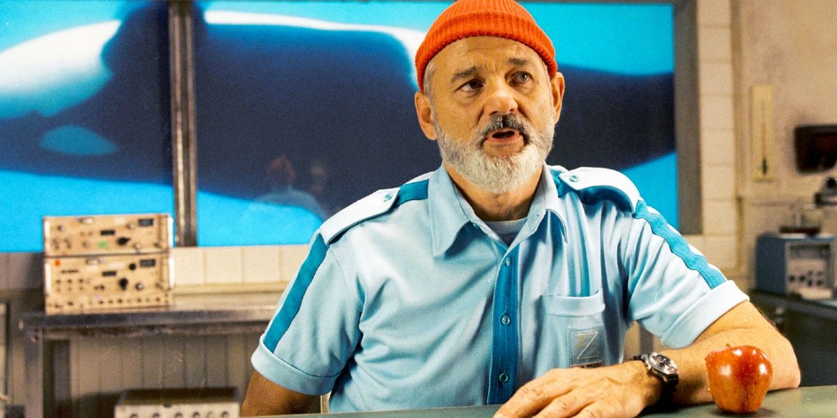 Steve (Bill Murray) sitting with whale swimming behind him in The Life Aquatic