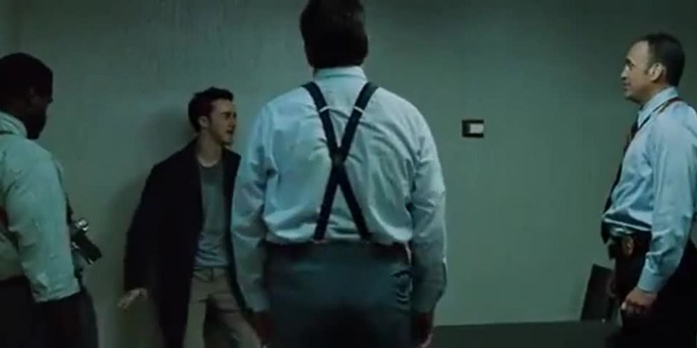 The Narrator surrounded by cops in the police station scene in Fight Club