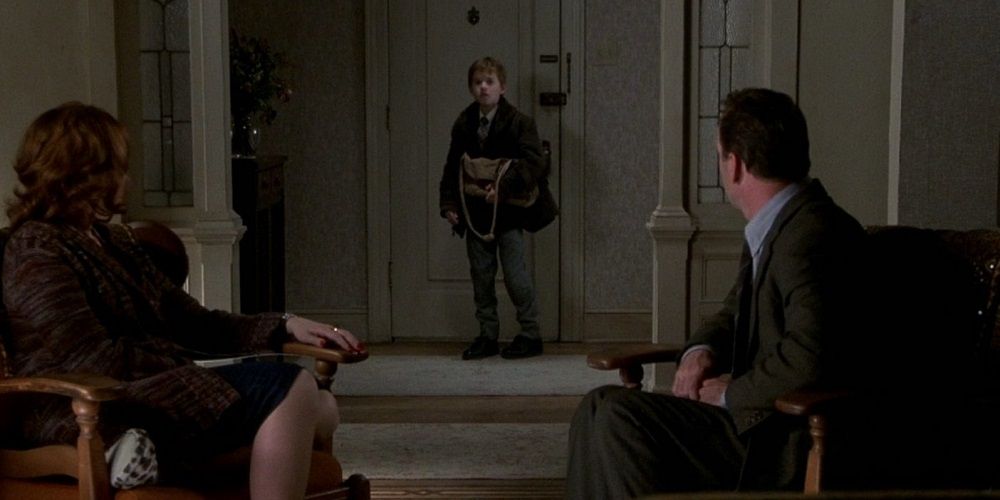 Malcolm and Lynn sit as Cole enters in The Sixth Sense