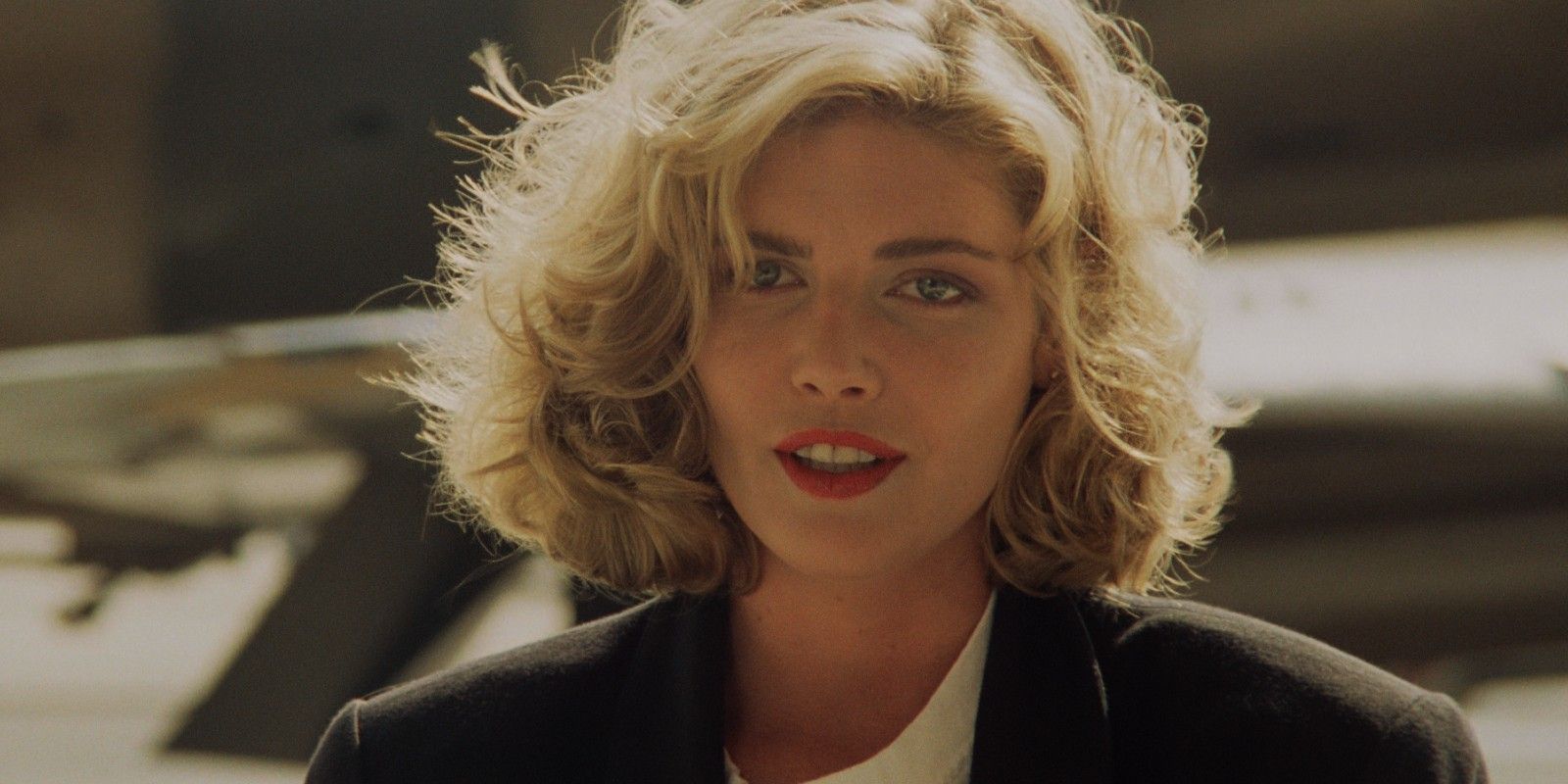 Charlie (Kelly McGillis) smiling while wind blows on her hair in Top Gun Maverick.