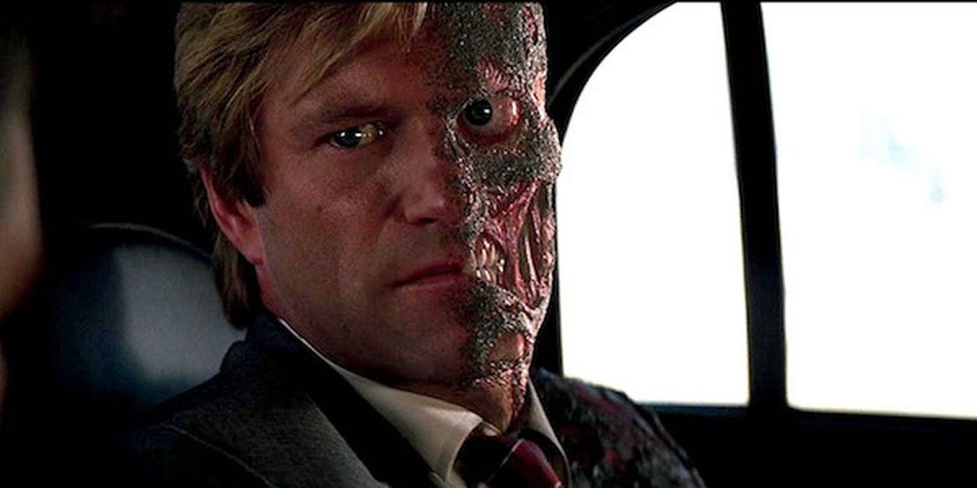 Two Face sitting in a car in The Dark Knight