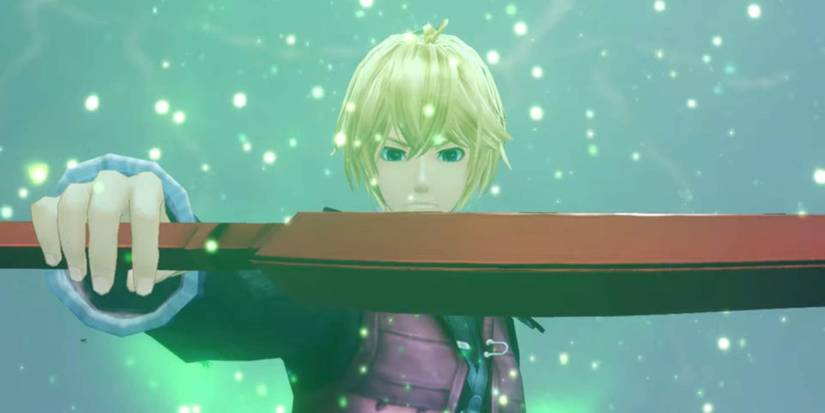 Shulk holding the Monado in his hand in Xenoblade Chronicles: Definitive Edition while green particles float around him.