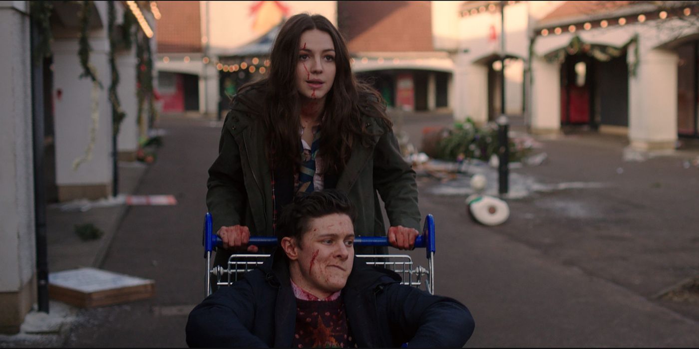 Anna pushing John in a trolley in Anna And The Apocalypse 