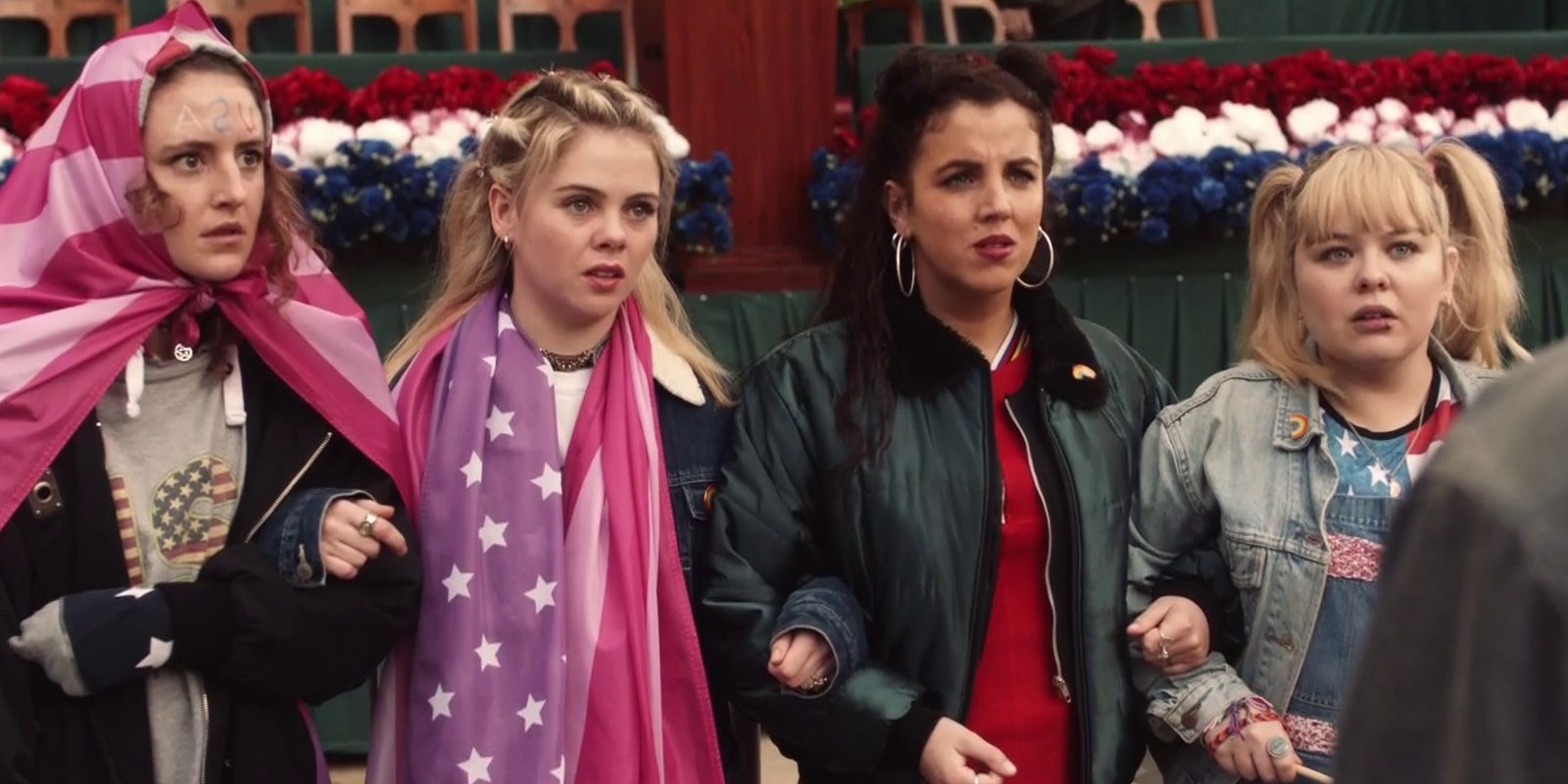 Orla, Erin, Clare, and Michelle face James in the crowd in Derry Girls episode &ldquo;The President&rdquo;