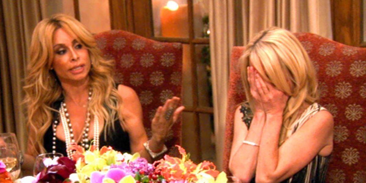 Faye Resnick sitting next to Kim Richards who is putting her hands on her face on The Real Housewives Of Beverly Hills