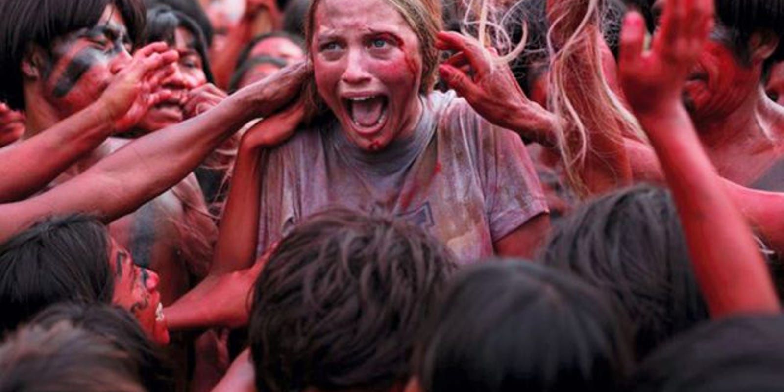 A woman is grabbed by many bloody hands from The Green Inferno