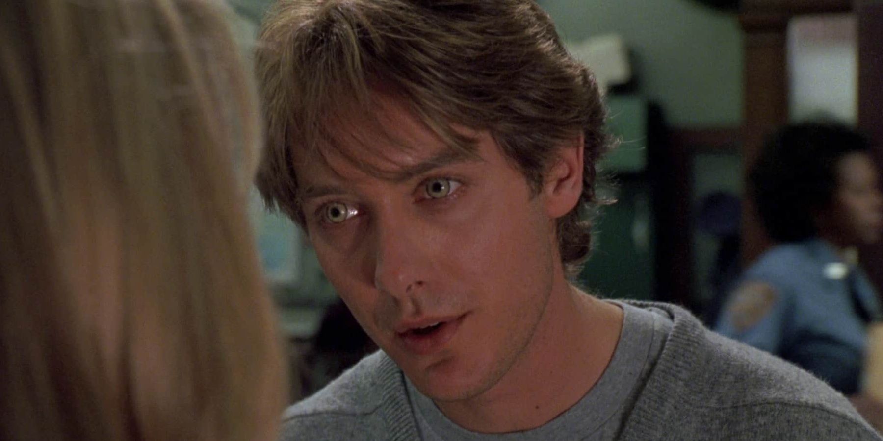 James Spader with glossy eyes looking at a woman in a scene from Wolf.