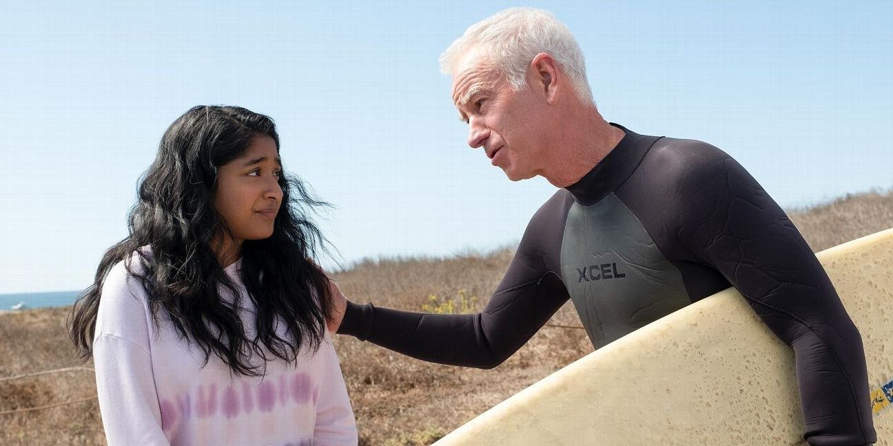 John McEnroe carries a surfboard and pats Devi on the shoulder in Never Have I Ever