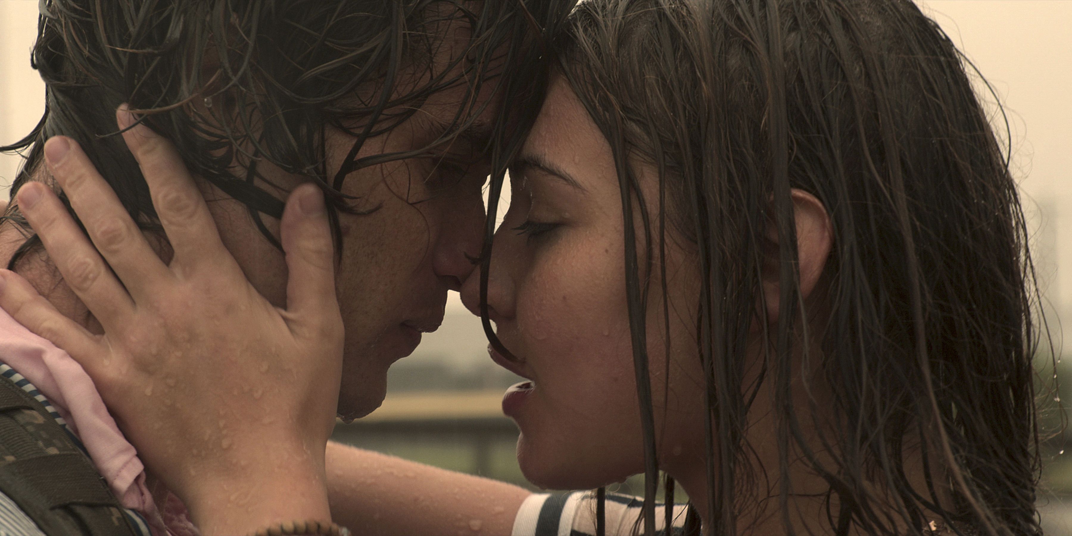 John B and Sarah embrace in the rain after their first day spent together in Outer Banks season 1