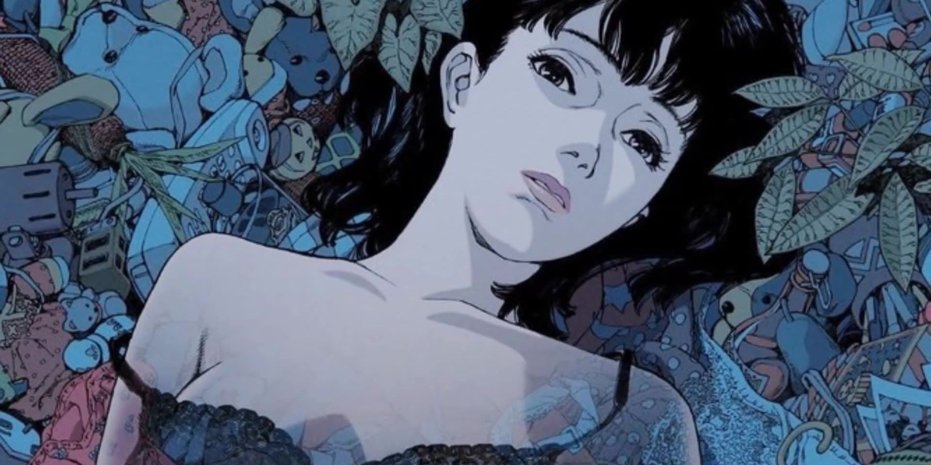 Mima lying on a bed of foliage in Perfect Blue.
