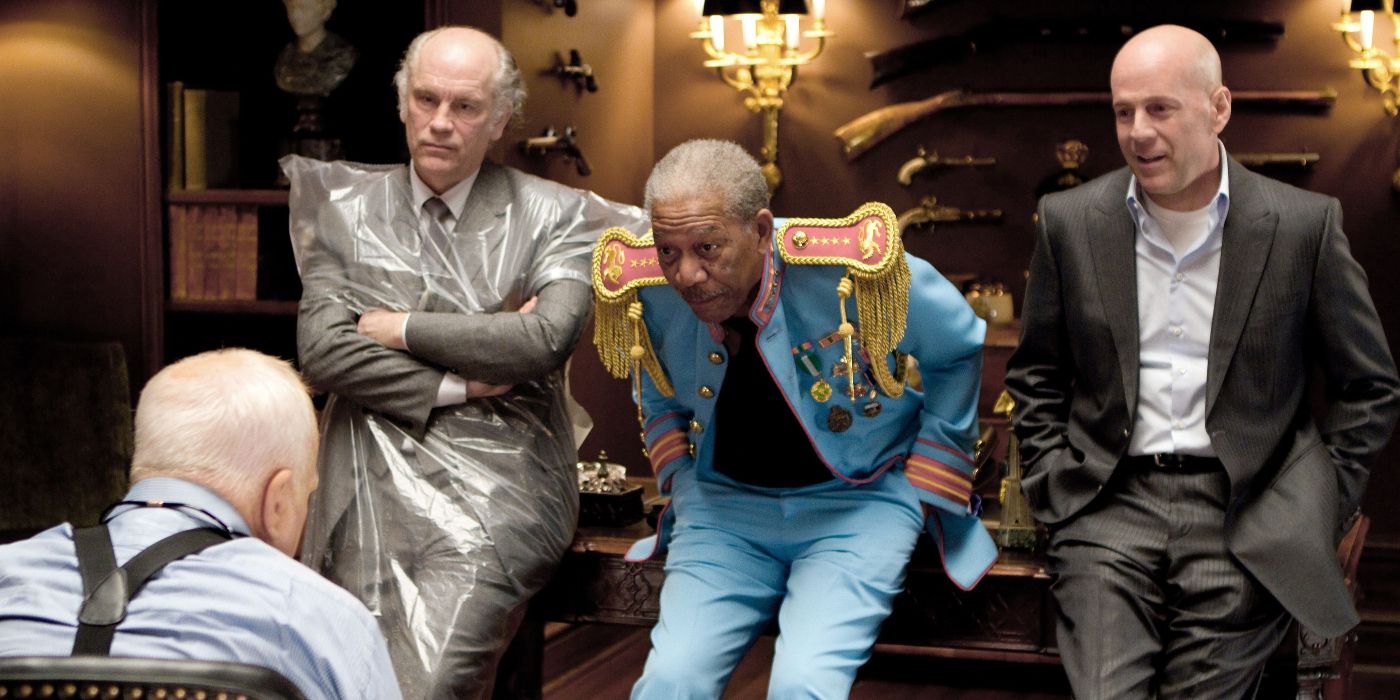 Bruce Willis in a suit, Morgan Freeman dressed as a matador, and John Malkovich in a plastic sheet in Red