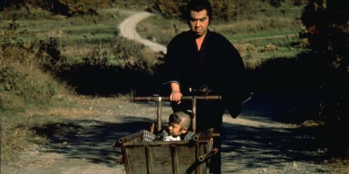 A samurai and his baby in a field in Shogun Assassin.