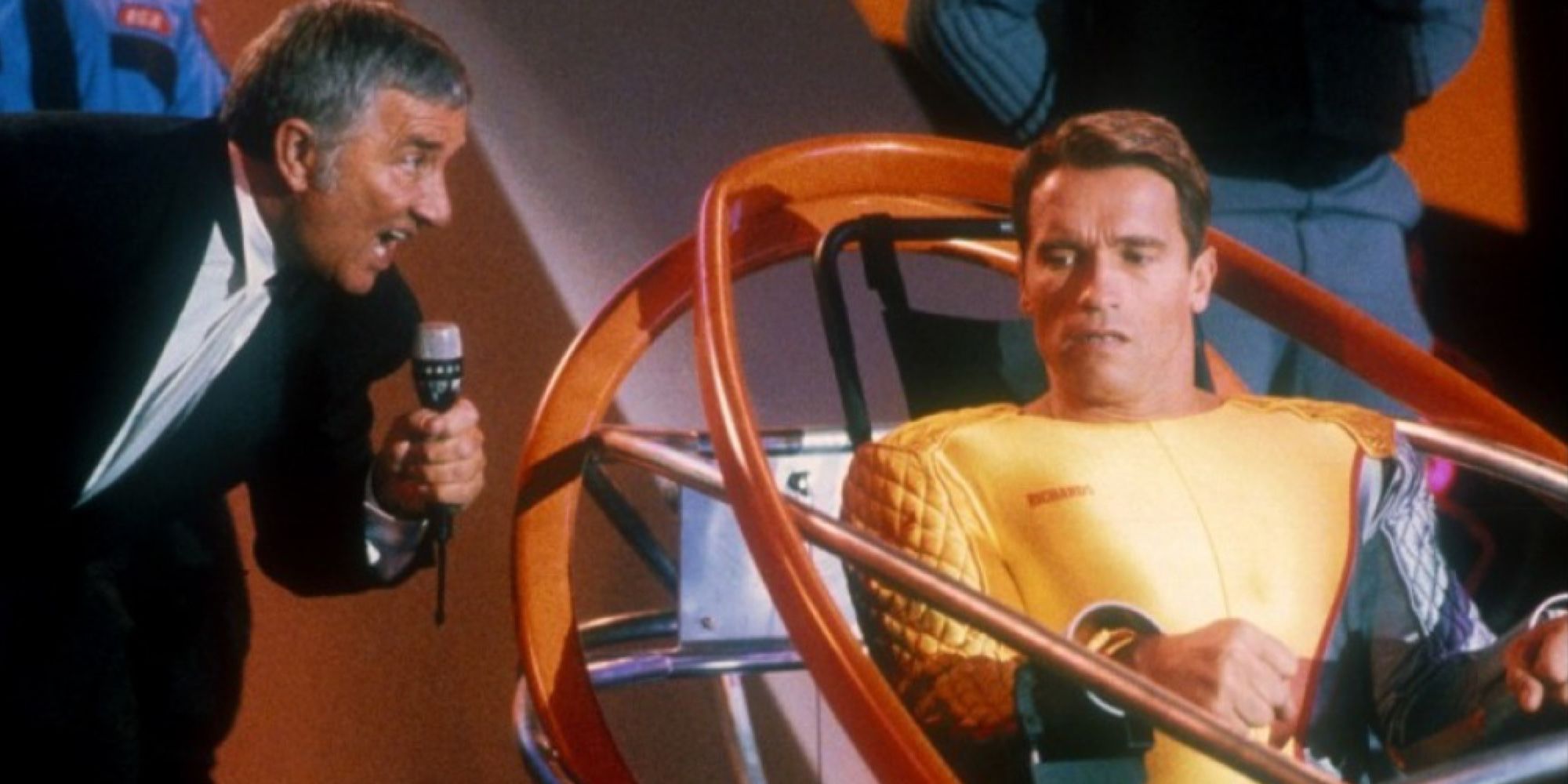 Arnold Schwarzenegger looks at Richard Dawson in The Running Man.