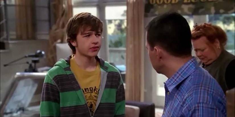 Alan talking to Jake in Two and a Half Men with Berta in the background