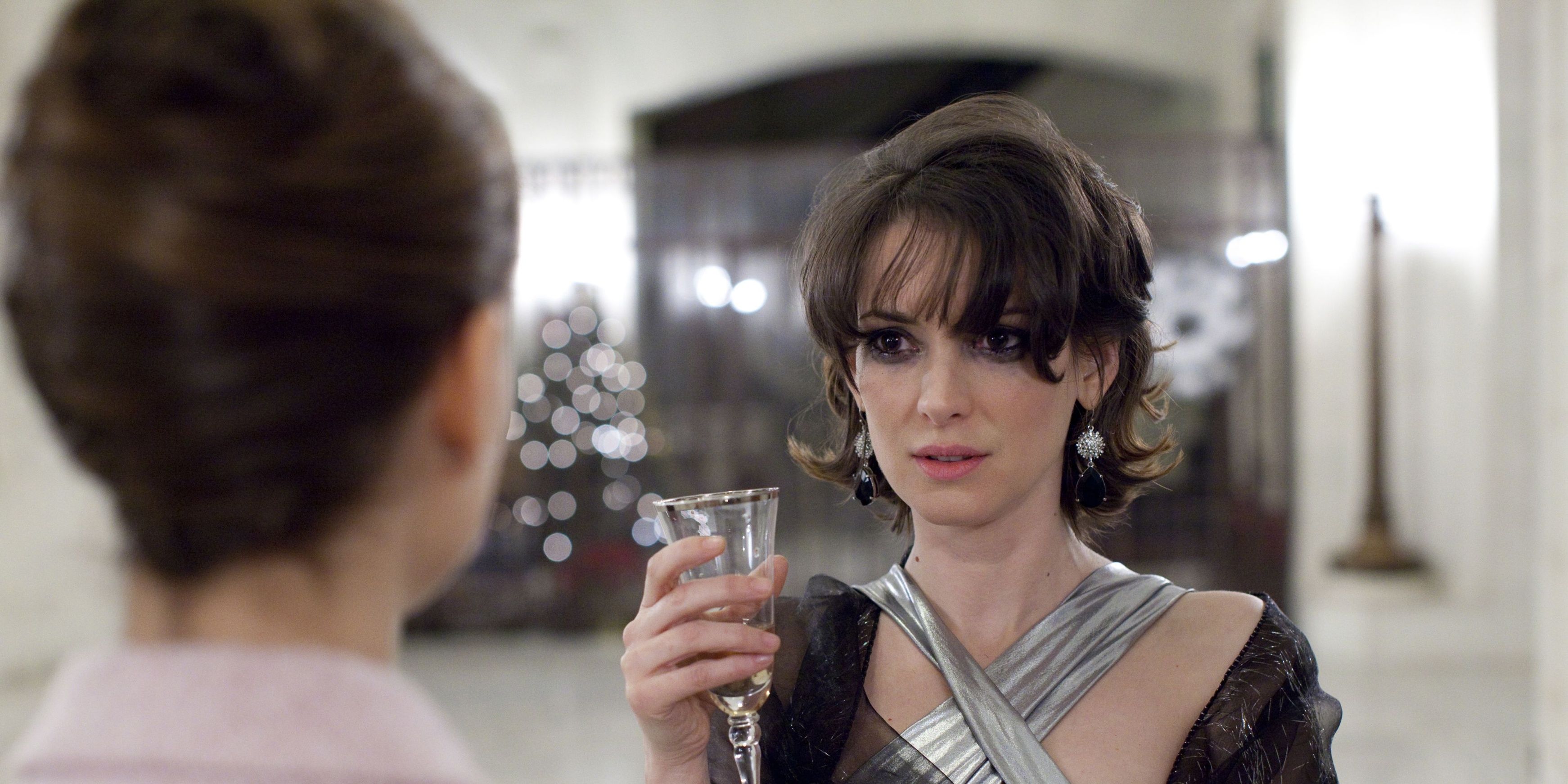 Beth drinks champagne at a party in Black Swan
