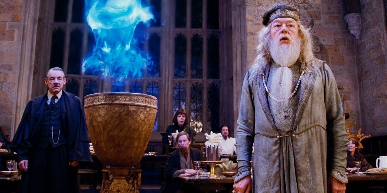 Dumbledore stands in the Great Hall with the Triwizard Cup
