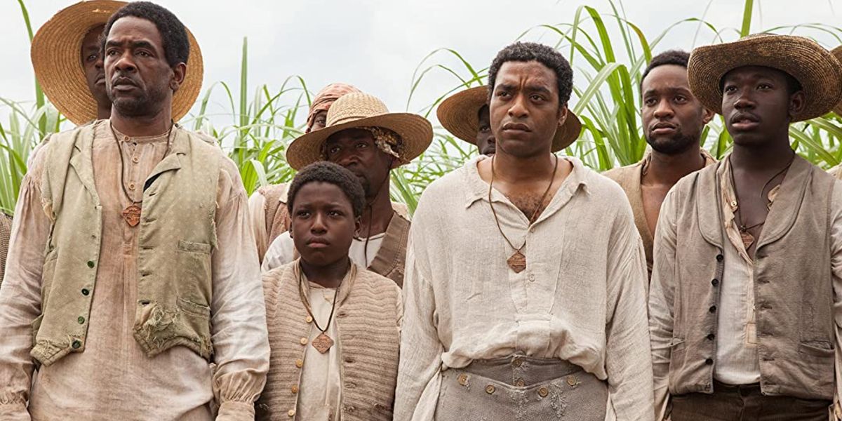 Cast members of 12 Years a Slave stand in front of plants