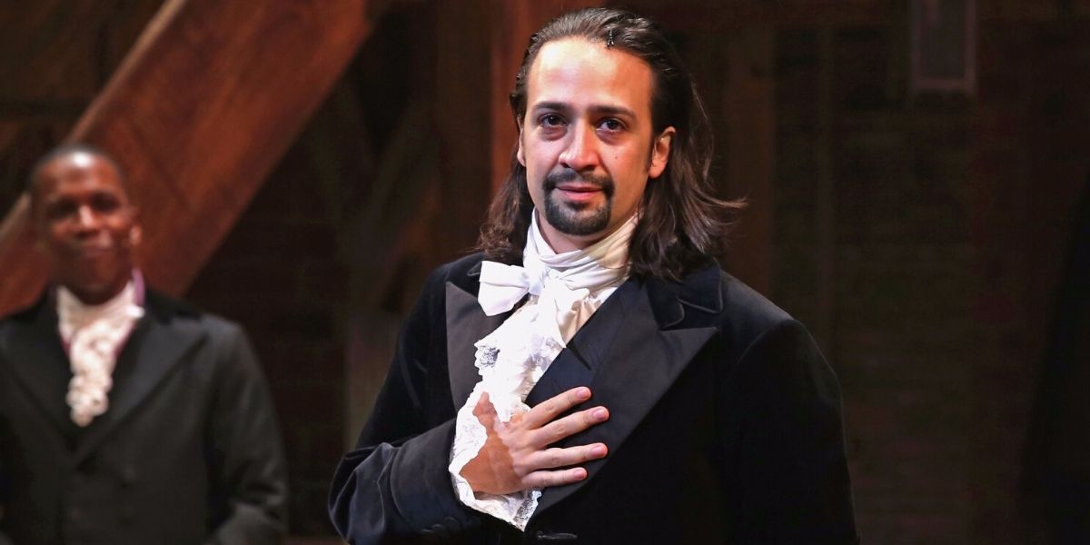 Lin-Manuel Miranda stands with his hand over his heart in Hamilton