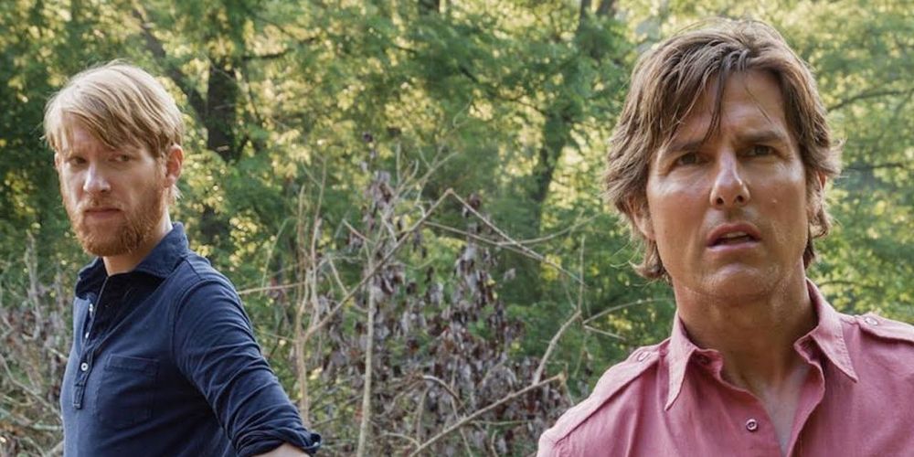 Domhnall Gleeson looking at Tom Cruise behind his back in American Made