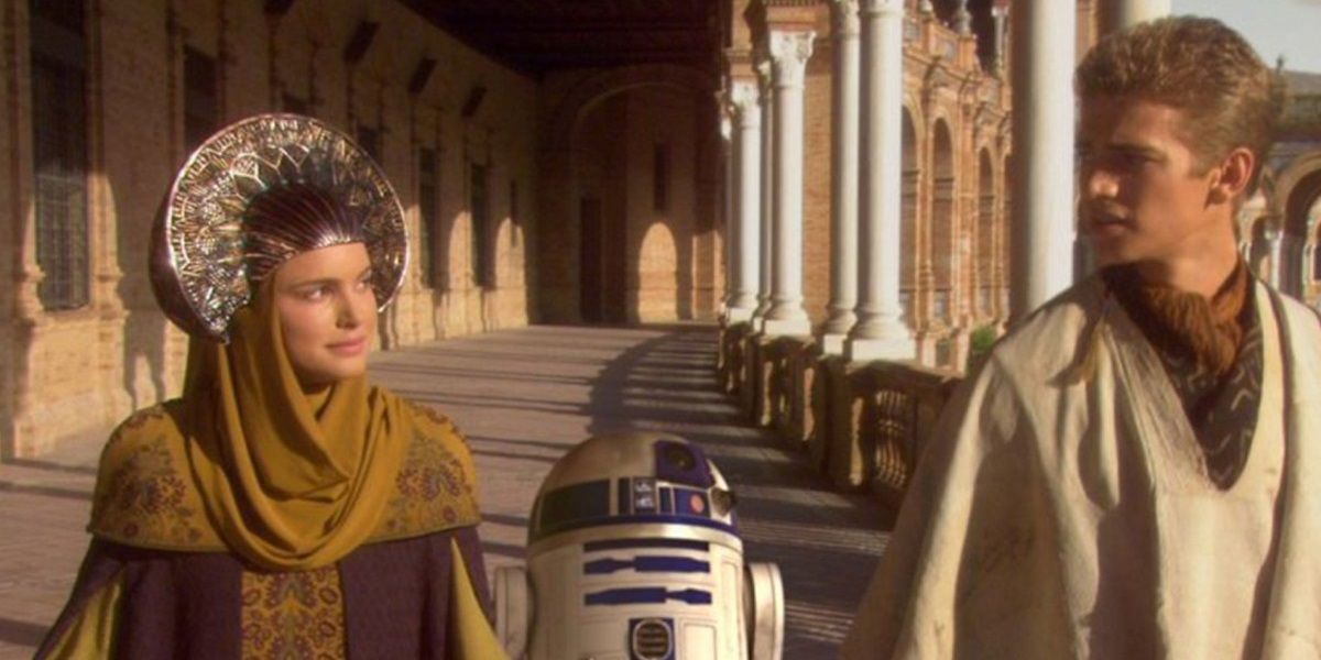 Padme Amidala walking with R2-D2 and Anakin Skywalker disguised as refugees in Star Wars Episode II Attack of the Clones