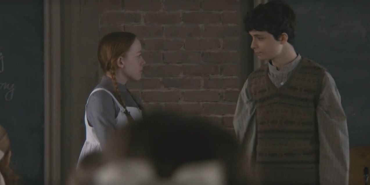 Anne and Gilbert stand at the front of the class for a spelling competition in Anne With An E