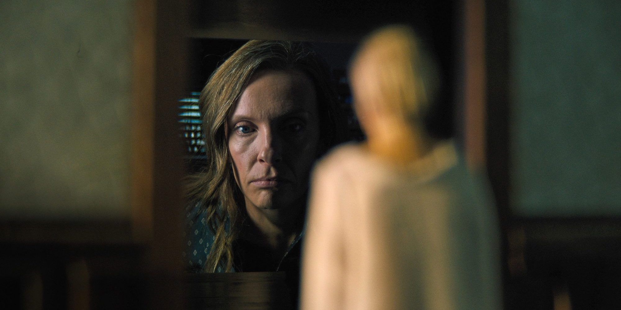 Annie looking at a model of her mother in Hereditary
