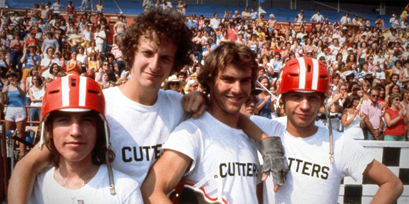 The cast of Breaking Away poses in front of a crowd