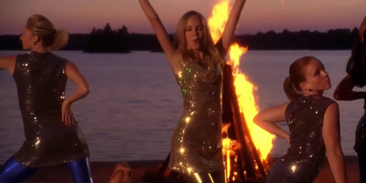 Tess performs in front of a fire in Camp Rock