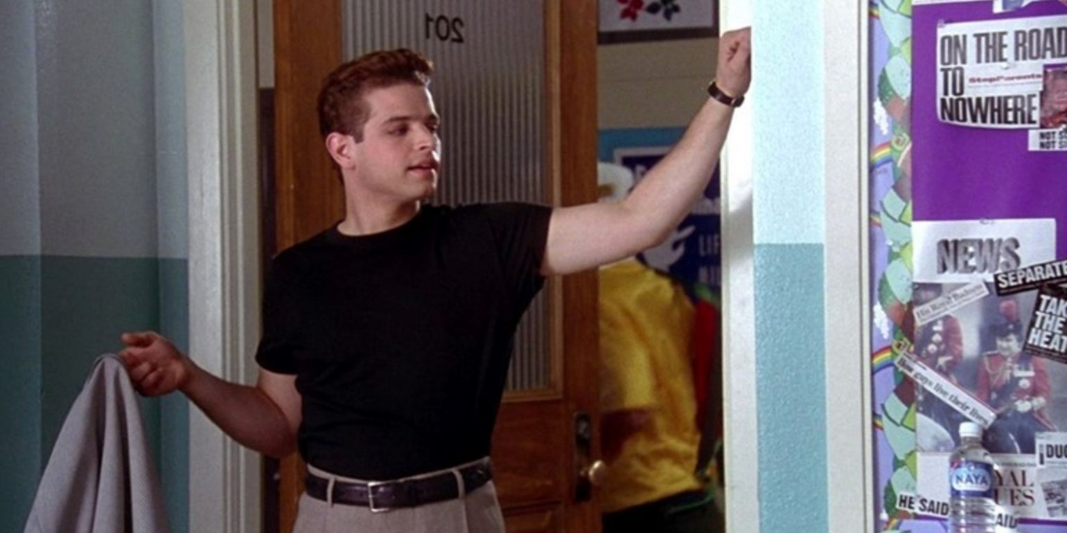 Christian enters the classroom with his jacket in one hand in his Clueless debut