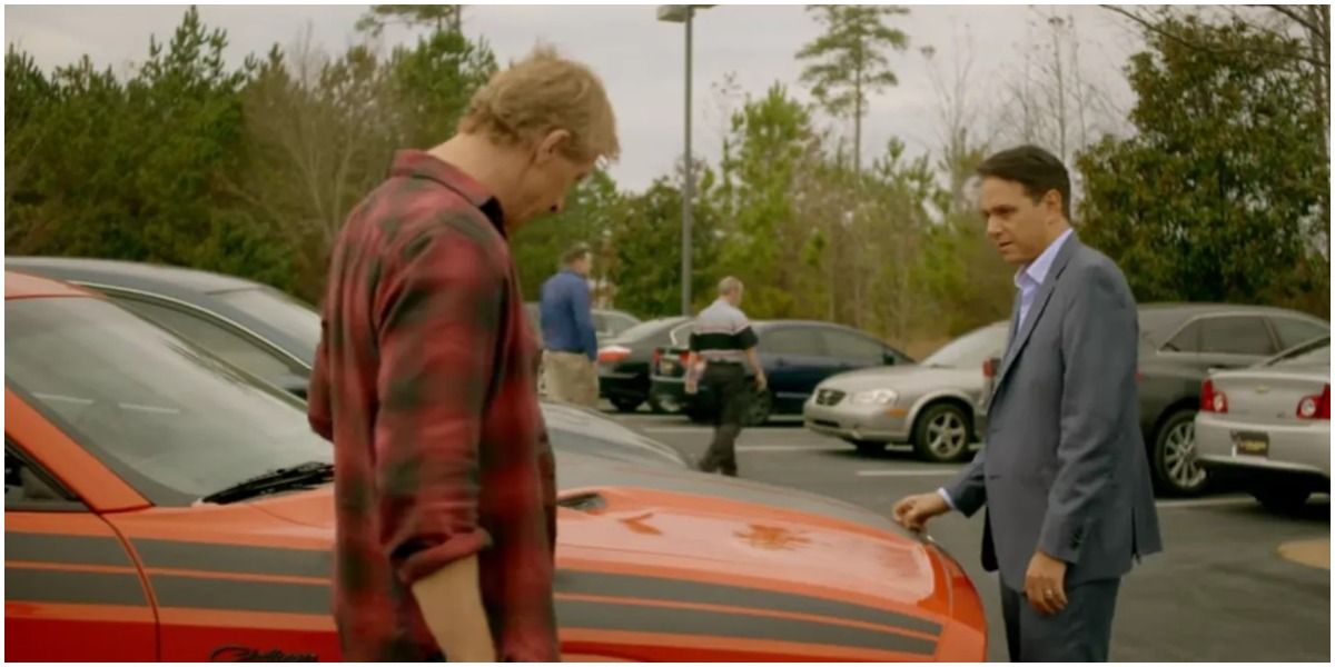 Johnny and Daniel talking around a car in Cobra Kai