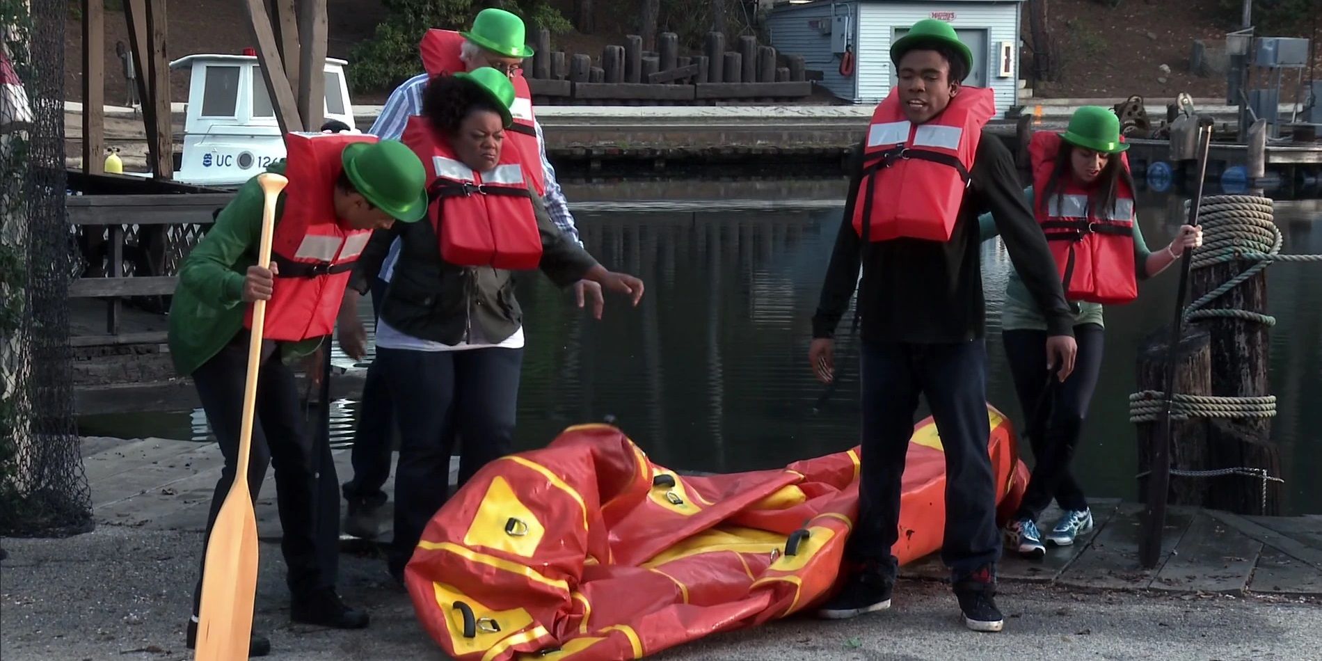 The cast wearing St.Patrick's day hats and life jackets