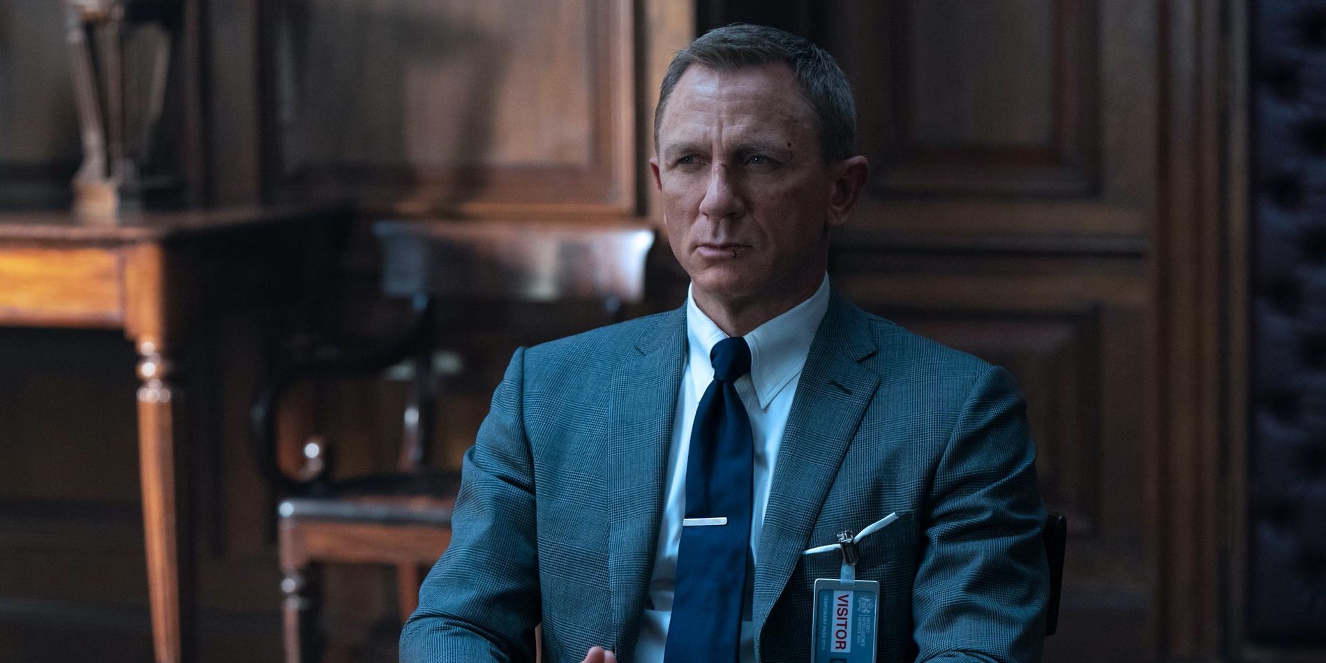 Daniel Craig as James Bond in M's office in No Time to Die
