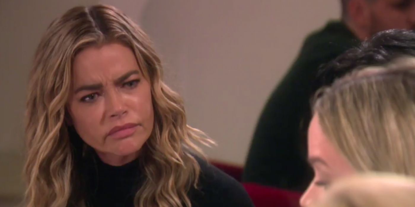 Denise Richards looking confused and upset on RHOBH while wearing a black top