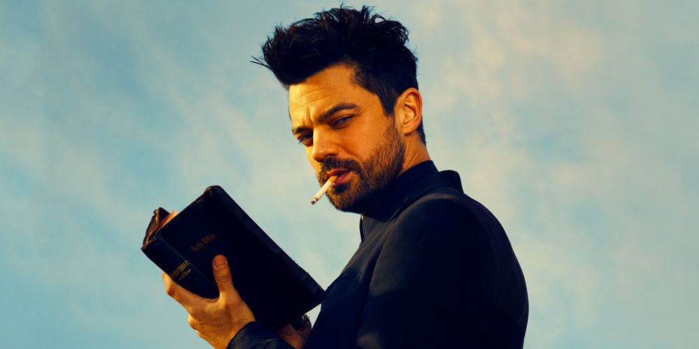 Dominic Cooper holding the Bible and smoking a cigarette in a still from Preacher