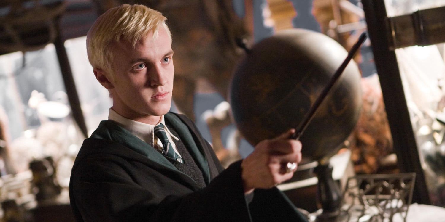 Draco Malfoy holding his wand