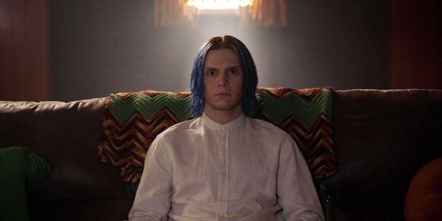 Kai Anderson sitting on a couch in American Horror Story: Cult