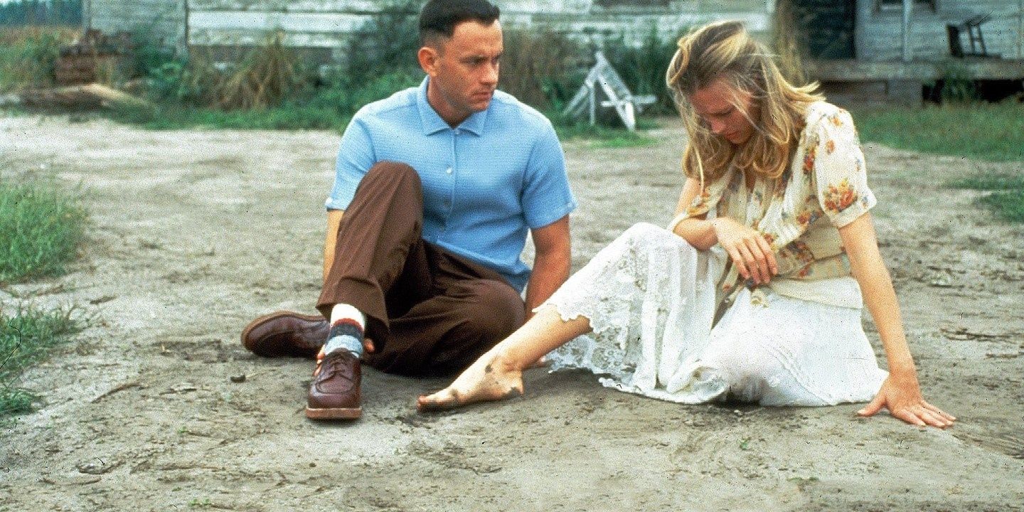 Jenny and Forrest sitting in the dirt in Forrest Gump