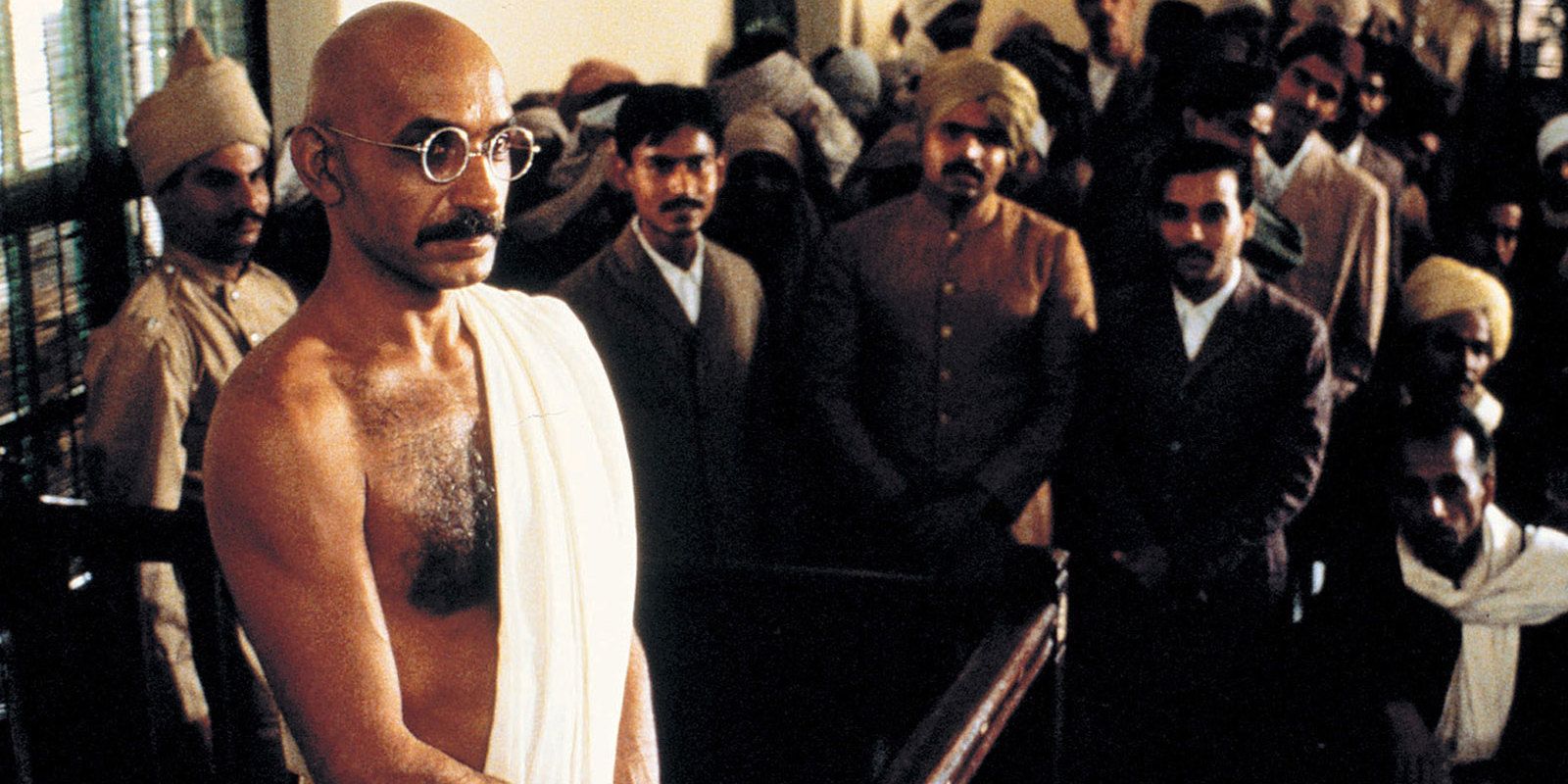 Gandhi stands in front of a group of Indians in Gandhi