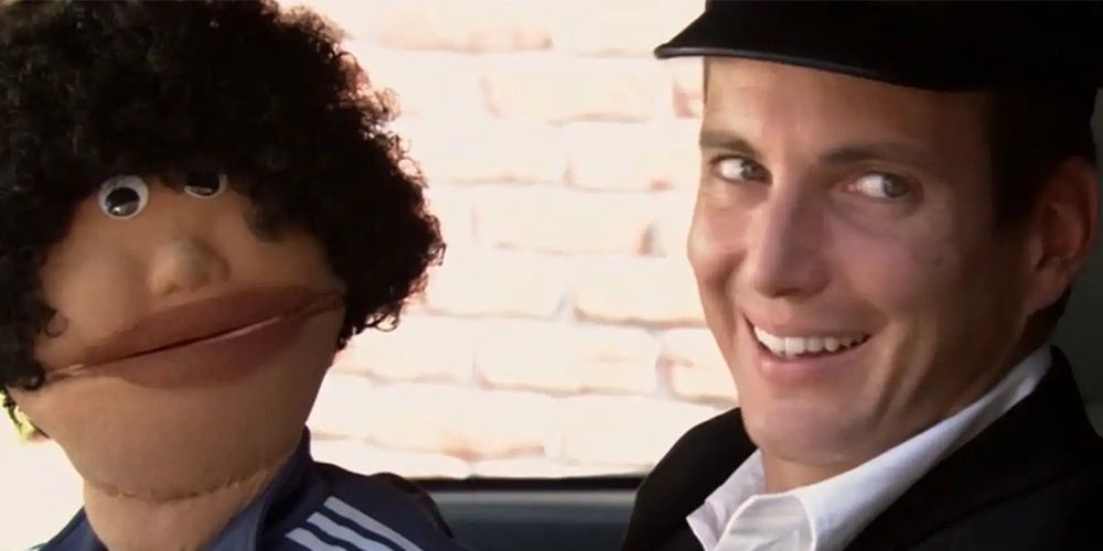 GOB and his puppet Franklin inside a acr in Arrested Development.