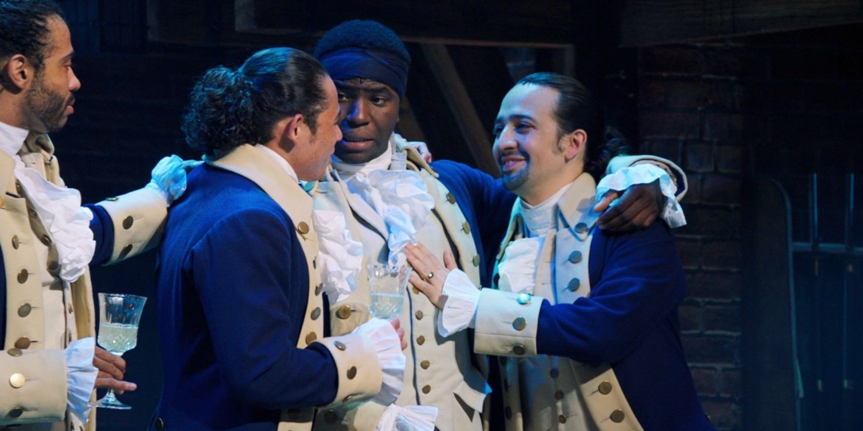 Hamilton embraces his friends in their blue coats in Hamilton