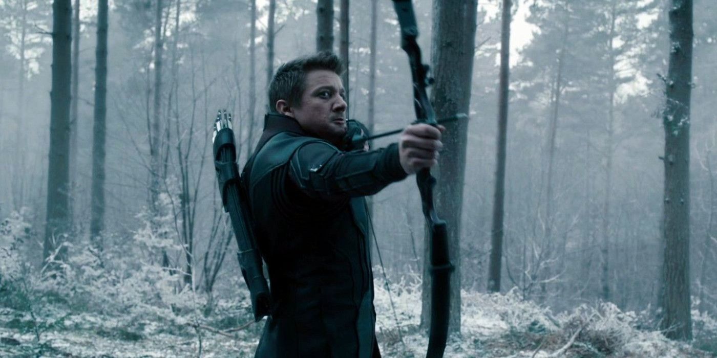 Jeremy Renner's Hawkeye aims a bow in a forest in Avengers: Age of Ultron