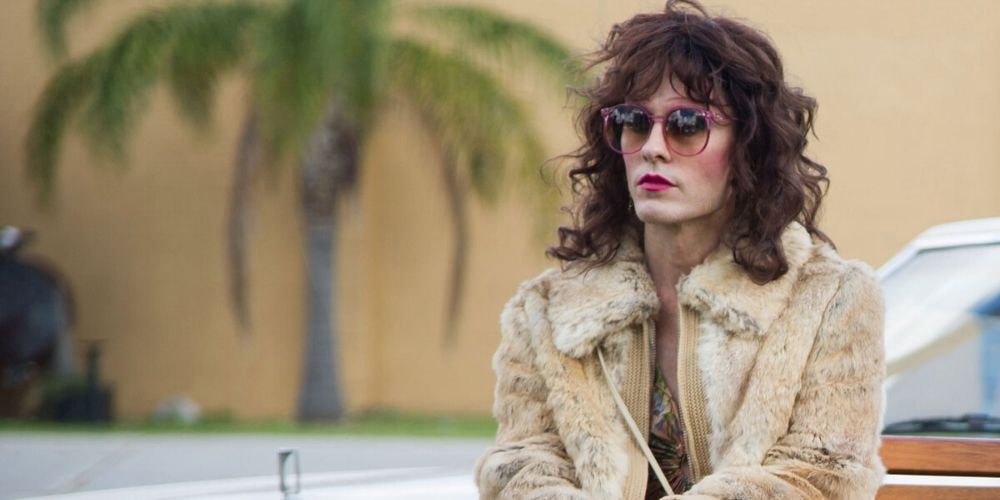Rayon sits by the car in Dallas Buyers Club