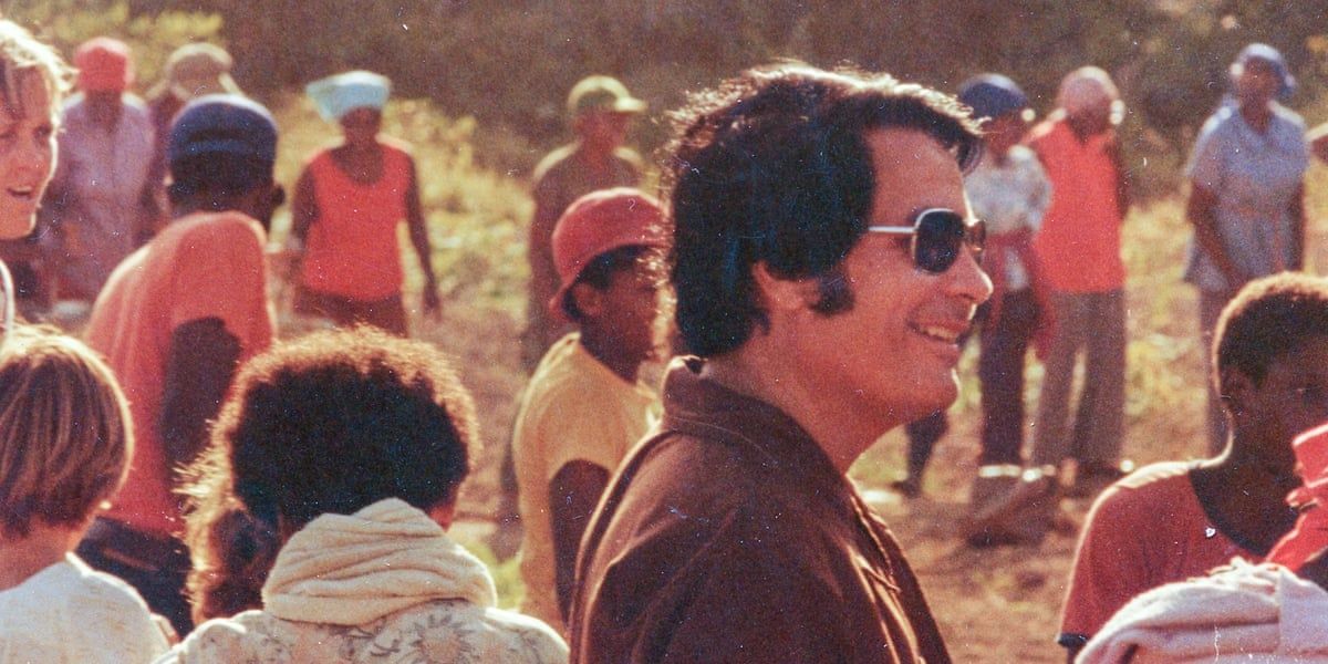 Jim Jones stands among his follower in Jonestown 
