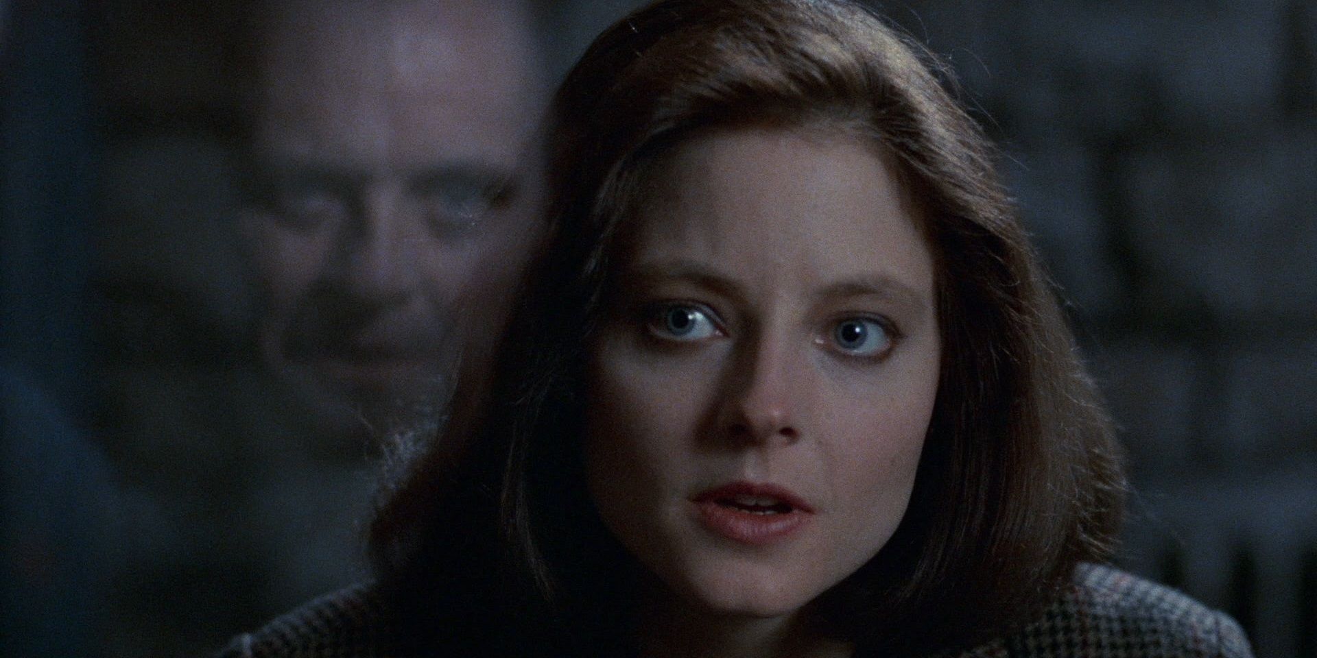 Jodie Foster looking intently at Anthony Hopkins in The Silence of the Lambs
