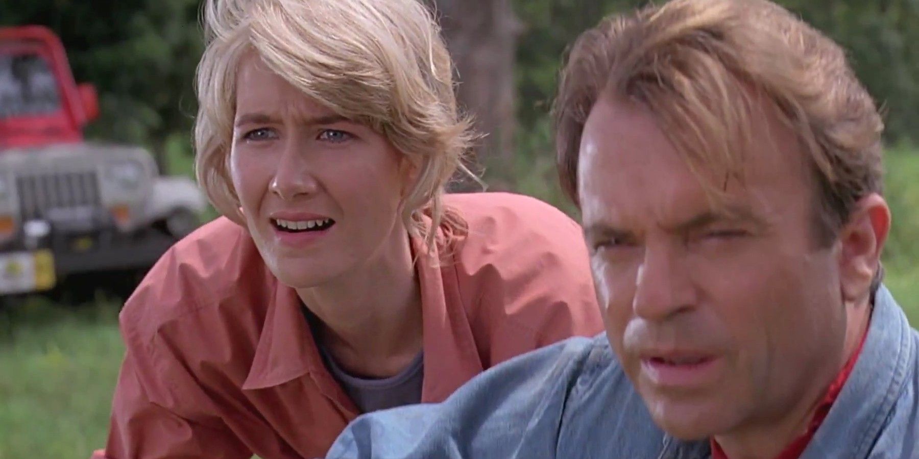 Sam Neil and Laura Dern look on in Jurassic Park