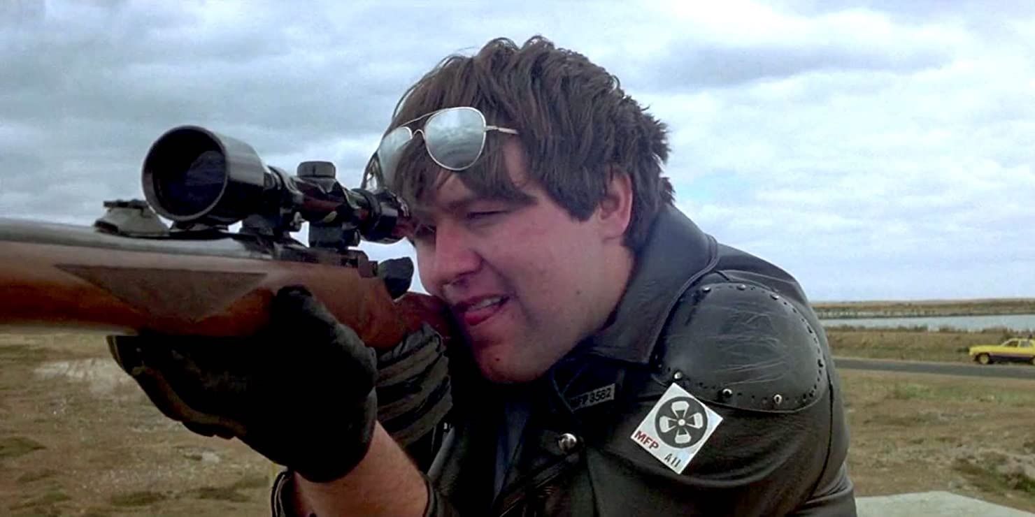 A police officer aiming a rifle in Mad Max