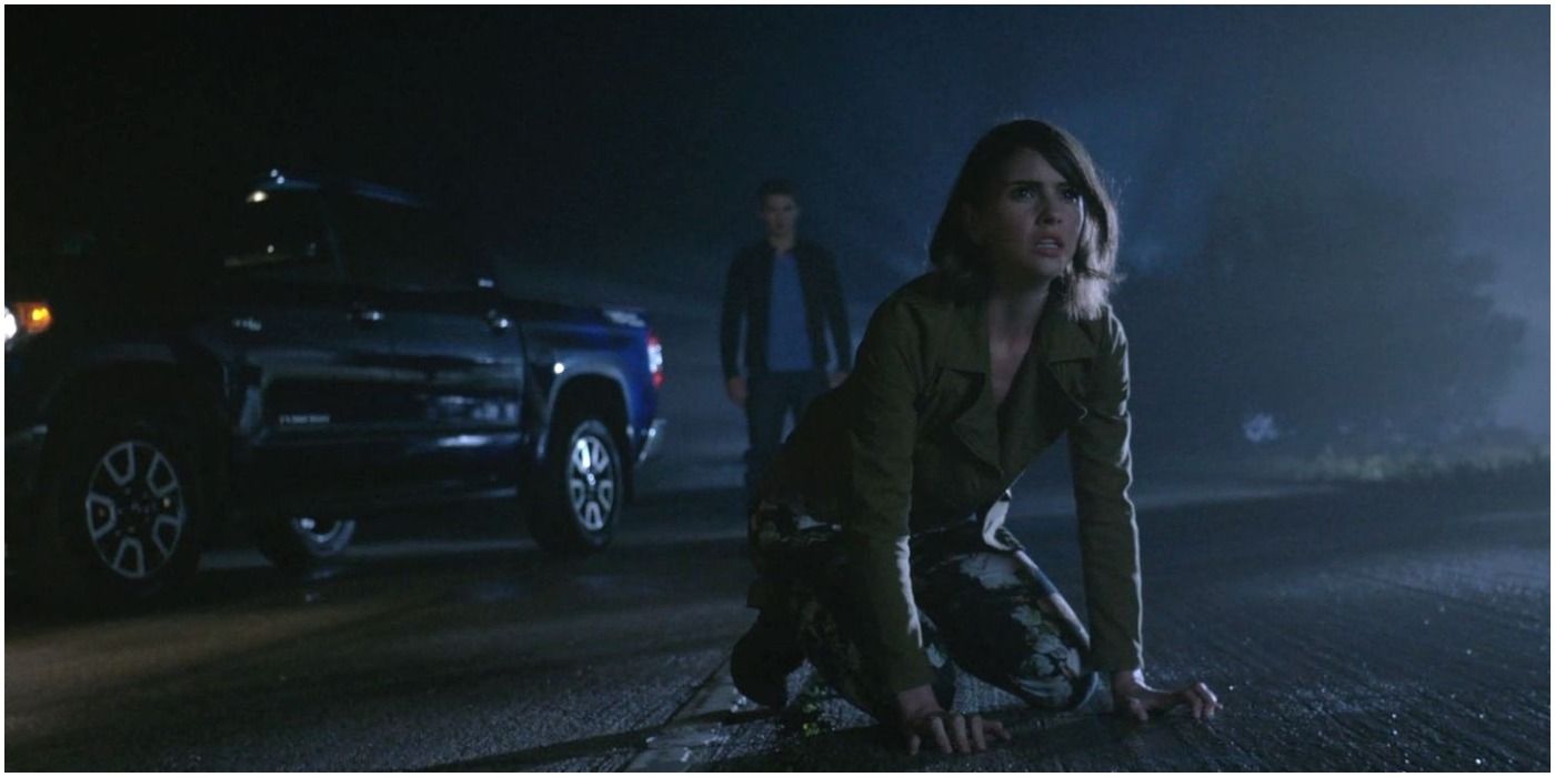 Malia kneeling on the ground with Theo behind her in Teen Wolf