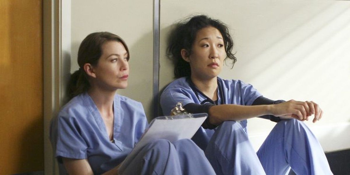Meredith and Cristina sitting on hospital floor in Grey's Anatomy